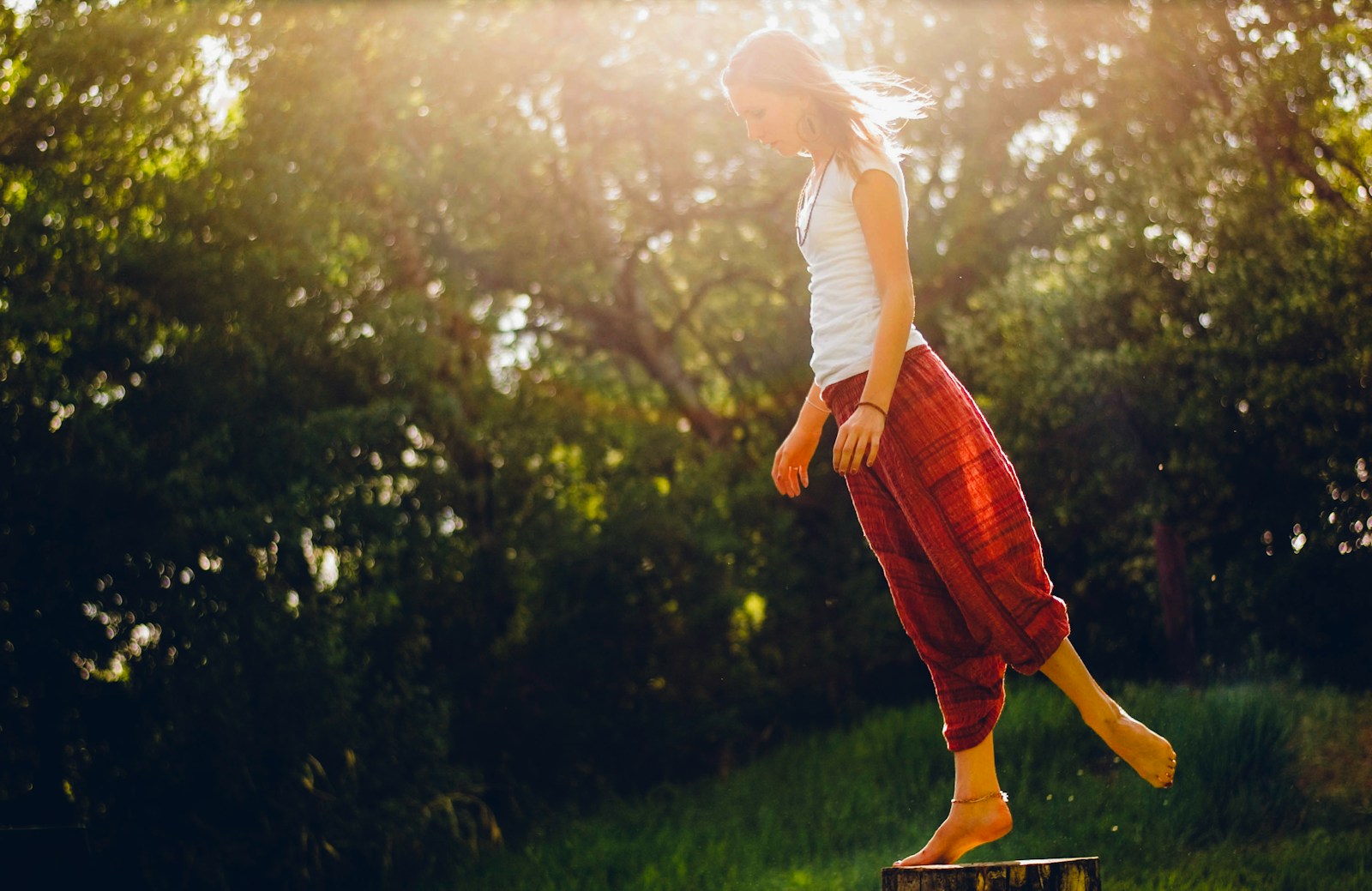 woman standing on wood log